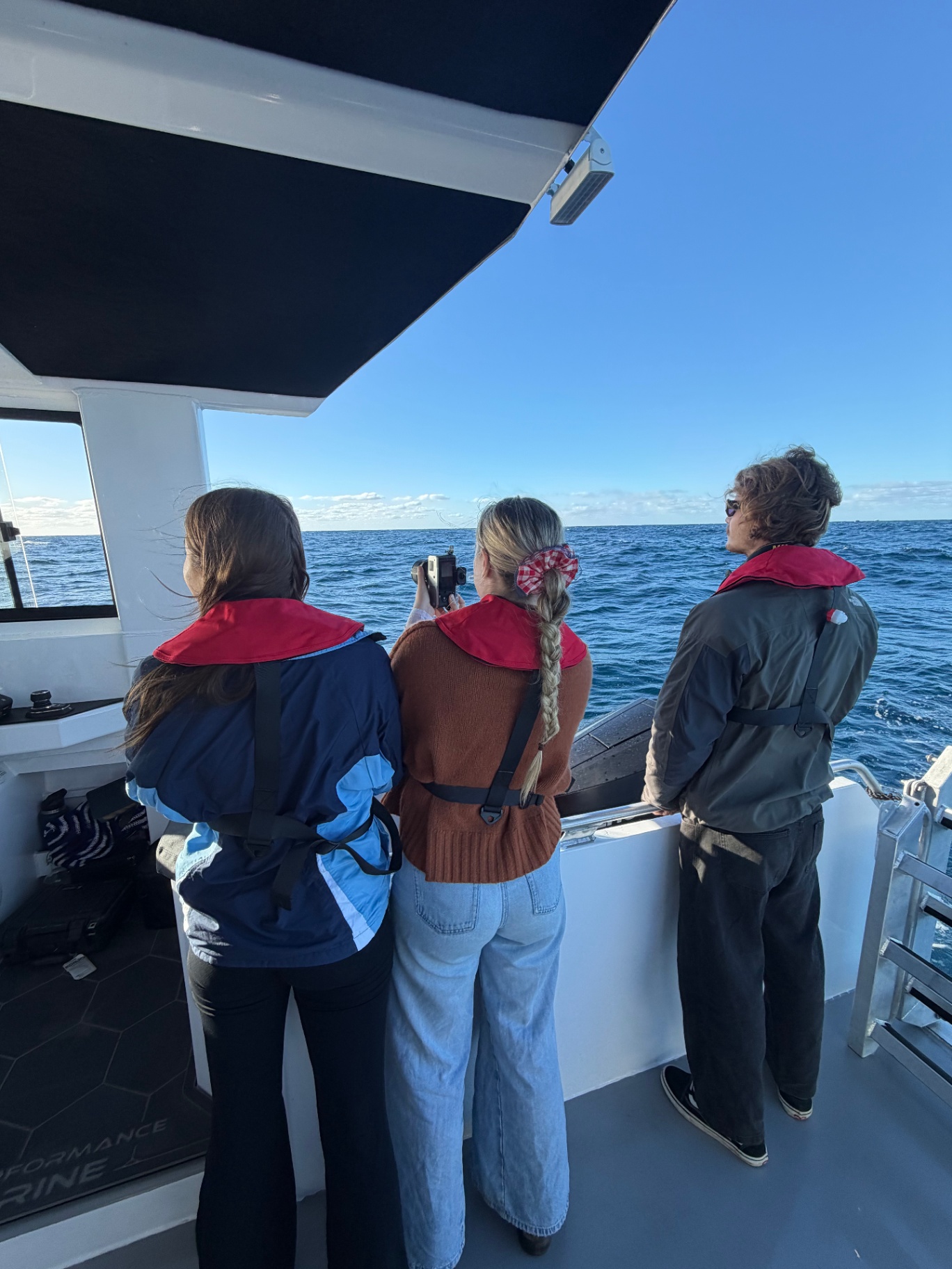 A family together on the bow of the vessel